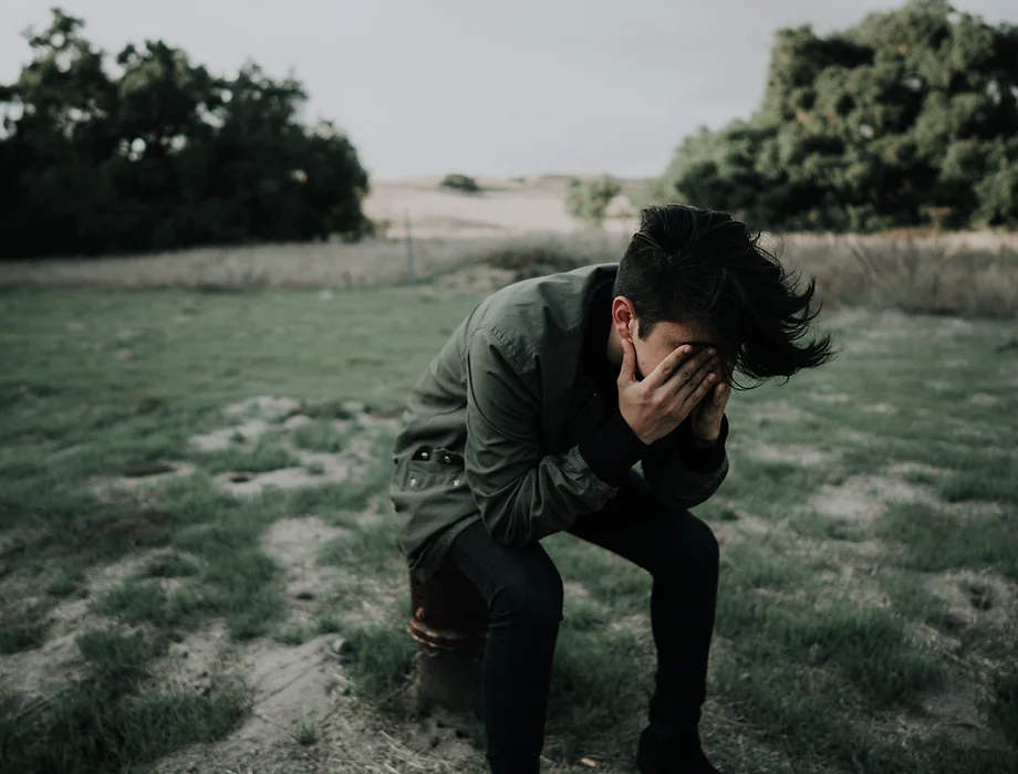 Stressed person alone in a field