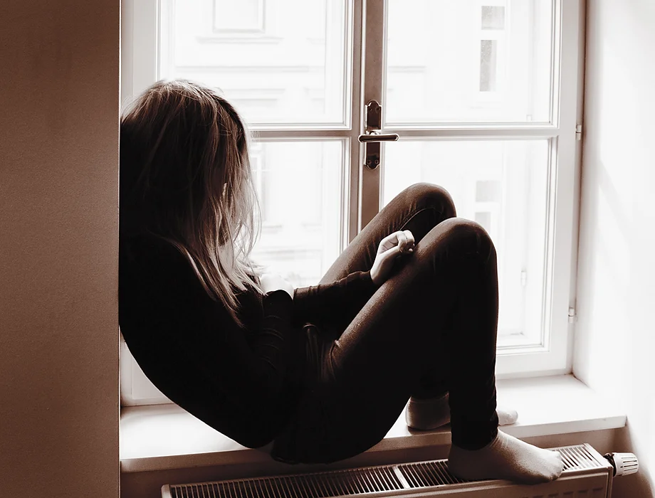 Person alone in a windowsill
