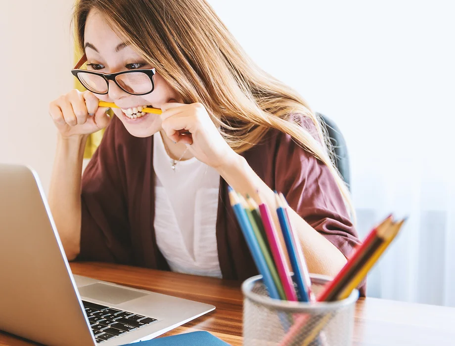 Person excitedly chewing a pencil